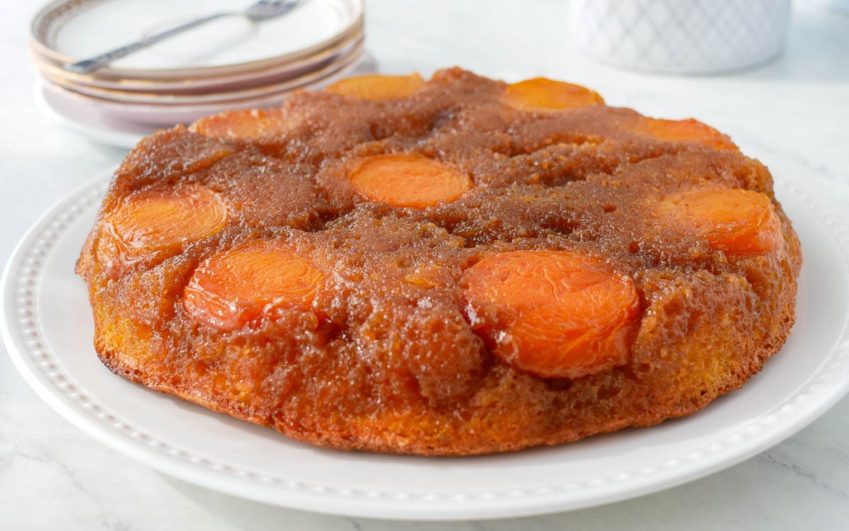 A Apricot Upside Down Cake on a white plate.
