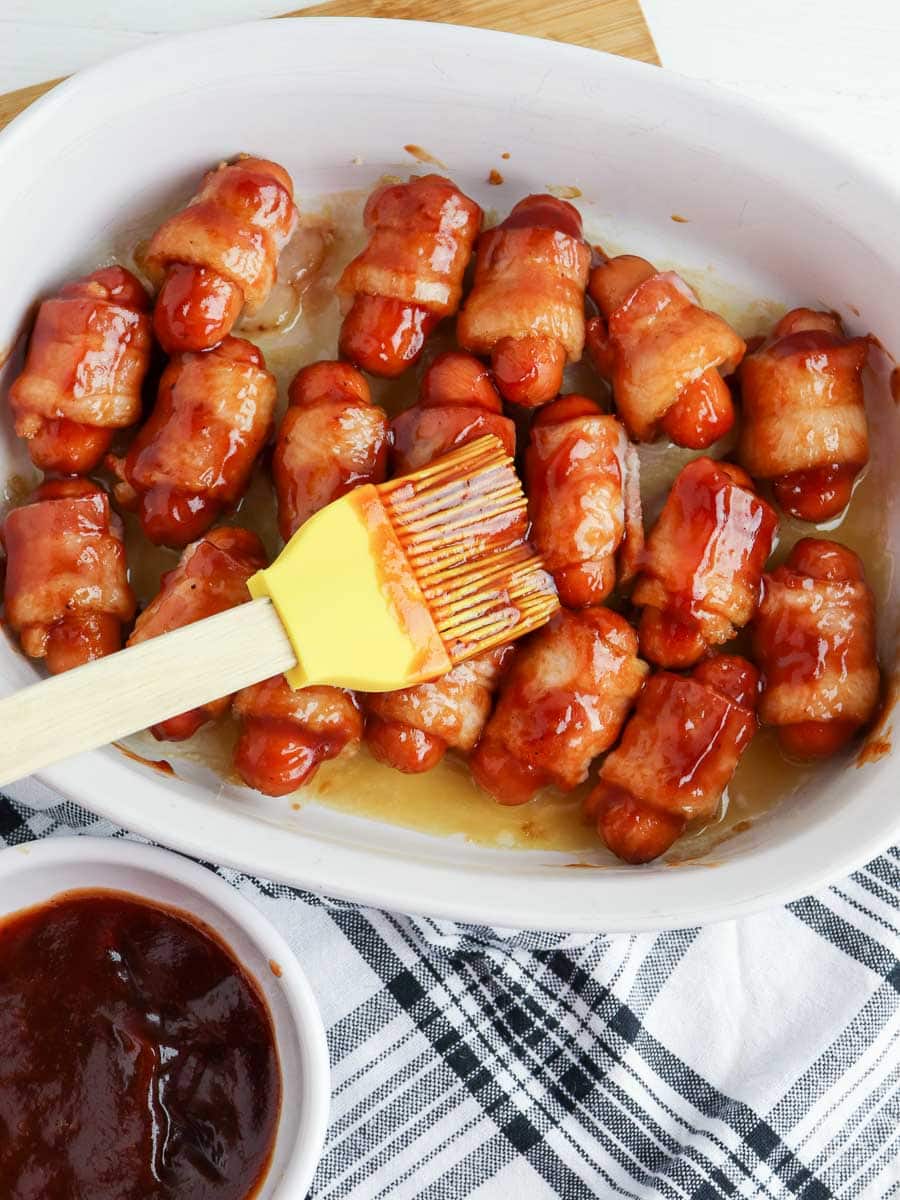 bacon wrapped little smokies in a baking dish.