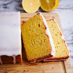 A slice of lemon loaf on a cutting board.