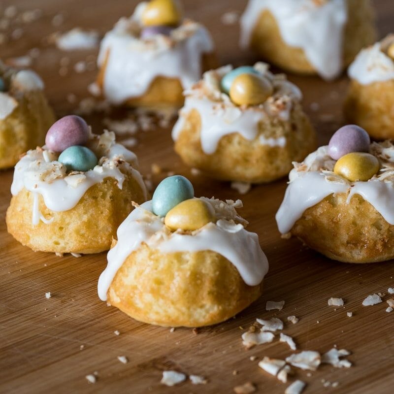 mini bundt cakes decorated with coconut and chocolate eggs to look like birds nests