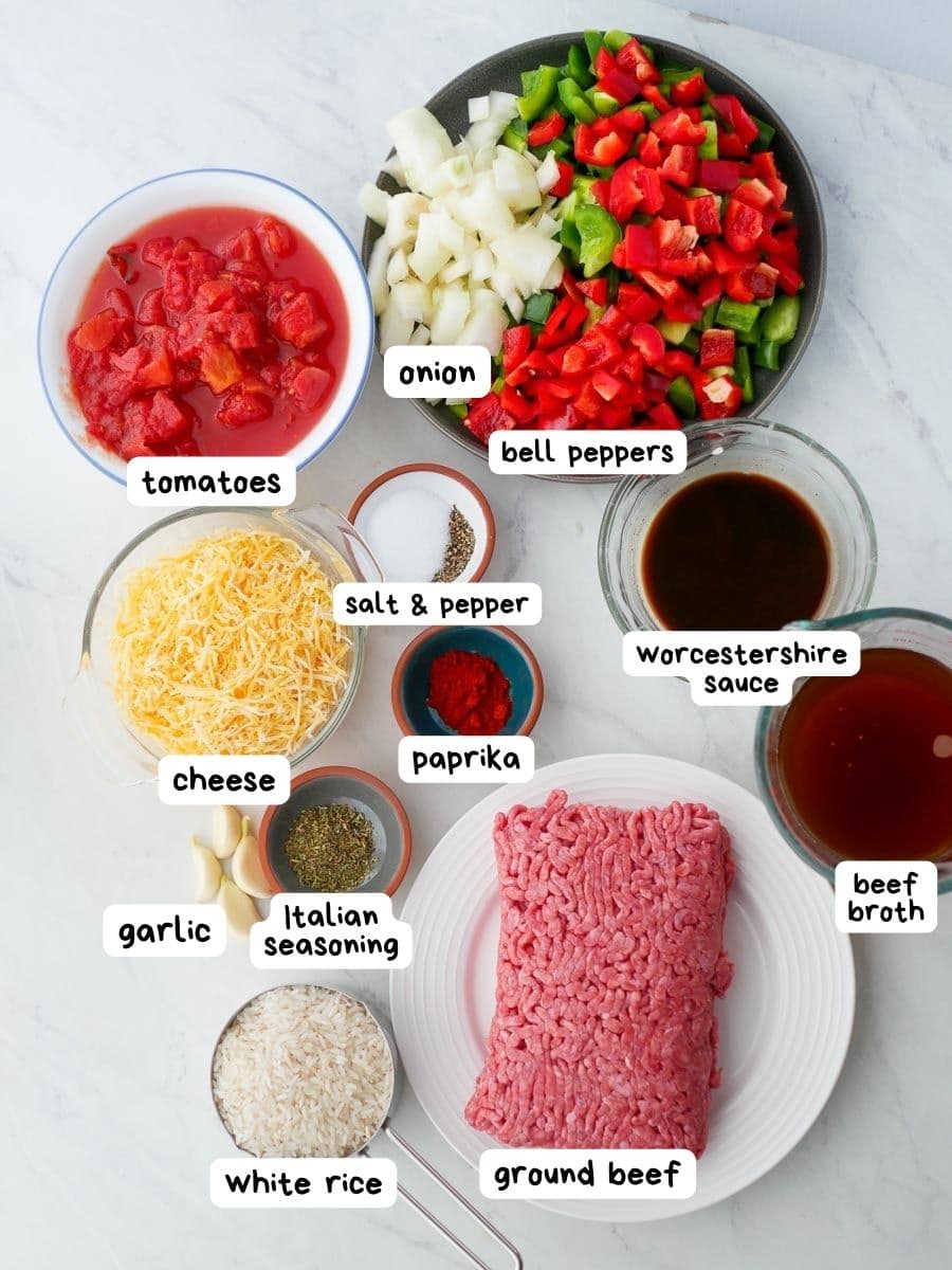 Ingredients for stuffed bell pepper casserole on a white table.