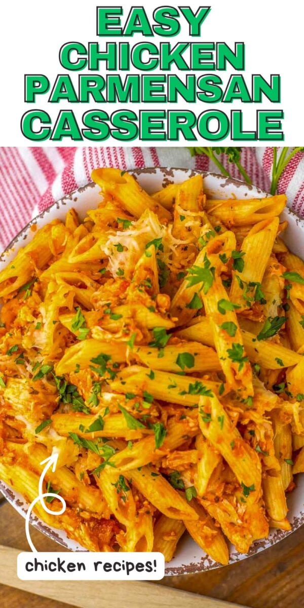 Bowl of baked penne pasta with chicken, marinara sauce, melted cheese, and chopped parsley. Text overlay reads "Easy Chicken Parm Casserole.