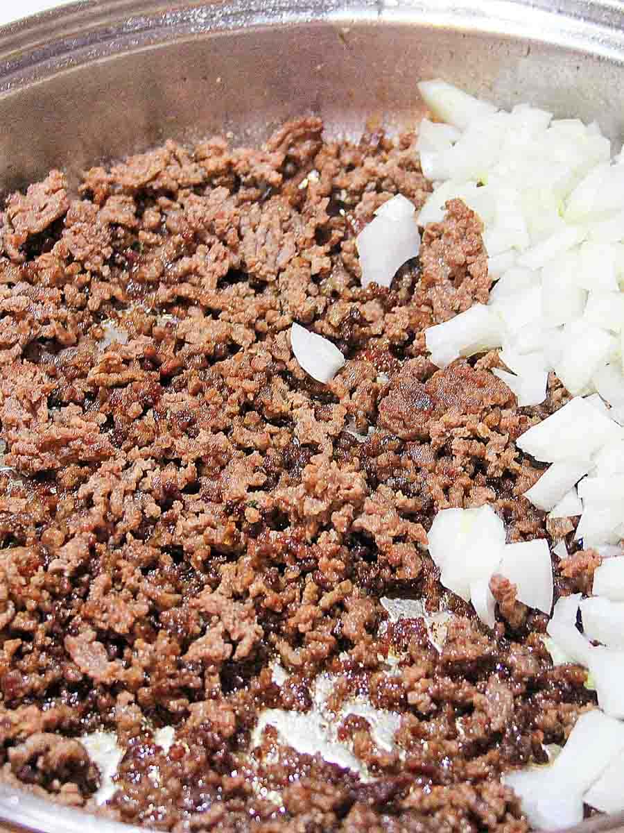 ground beef and onions cooking in skillet