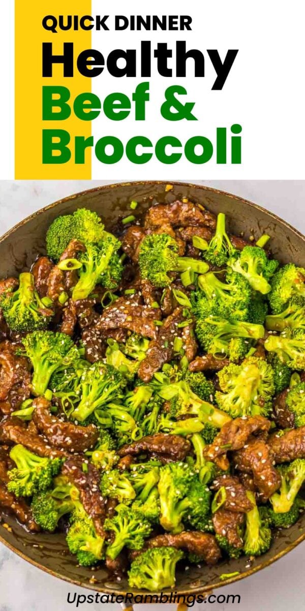 A skillet filled with savory beef and broccoli strips and tender florets in a rich brown sauce, all topped with sesame seeds.