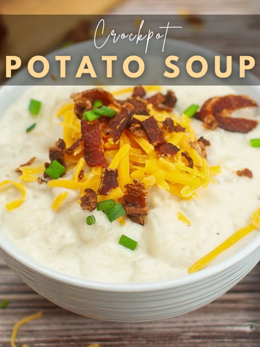 A bowl of creamy slow cooker potato soup topped with shredded cheddar cheese, crispy bacon pieces, and chopped green onions, labeled "Crockpot Potato Soup.