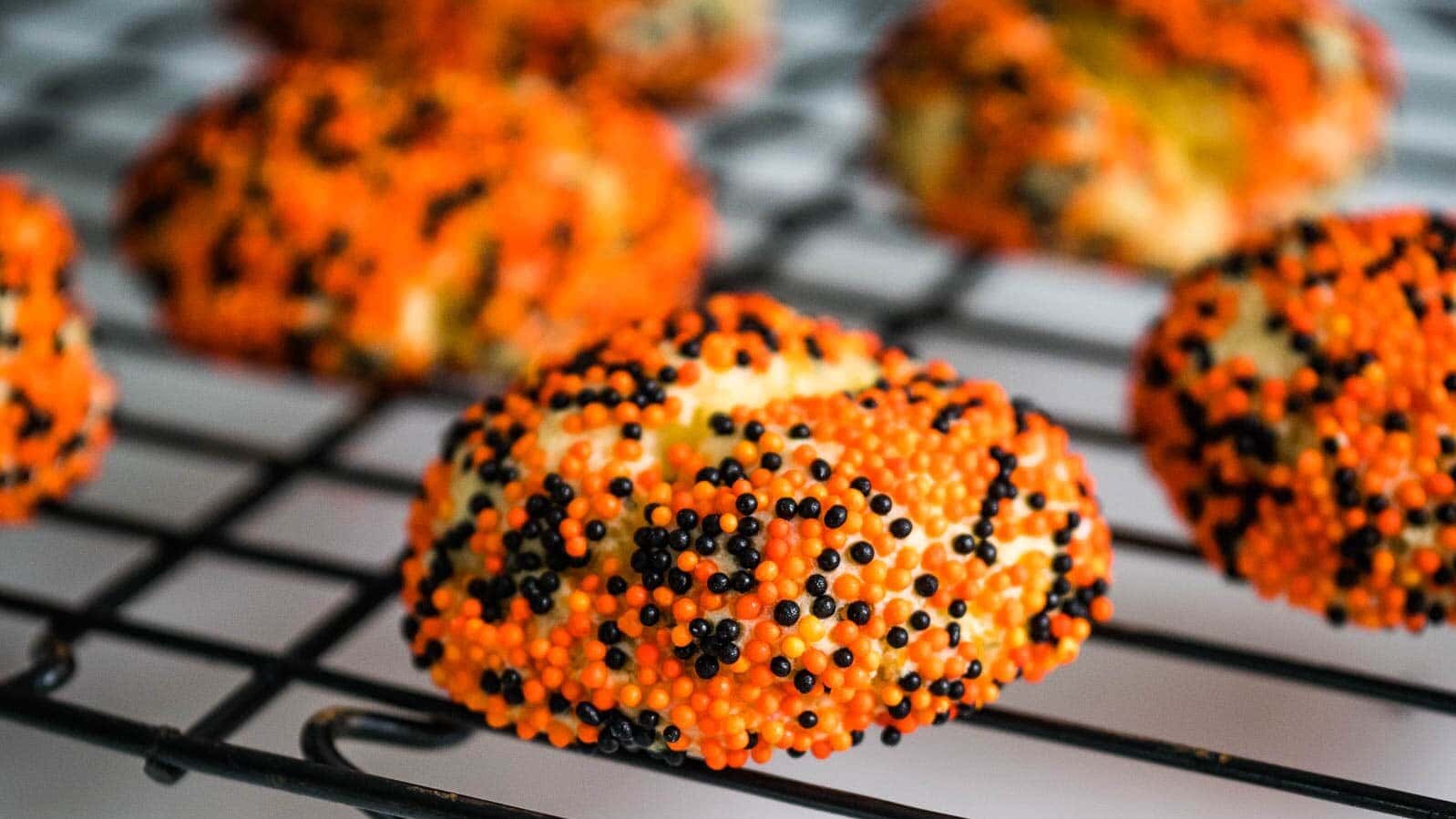 Cake Mix Cookies with Cream Cheese stacked up on a cutting board.