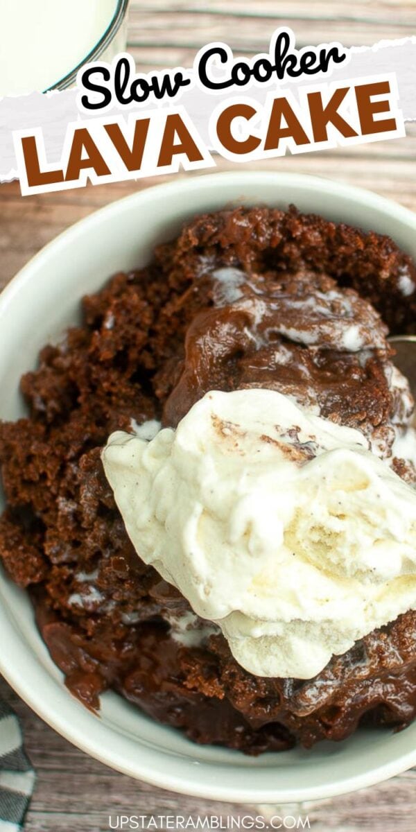 A bowl of slow cooker chocolate lava cake topped with vanilla ice cream, with a glass of milk in the background. Text overlay reads "Slow Cooker Lava Cake.