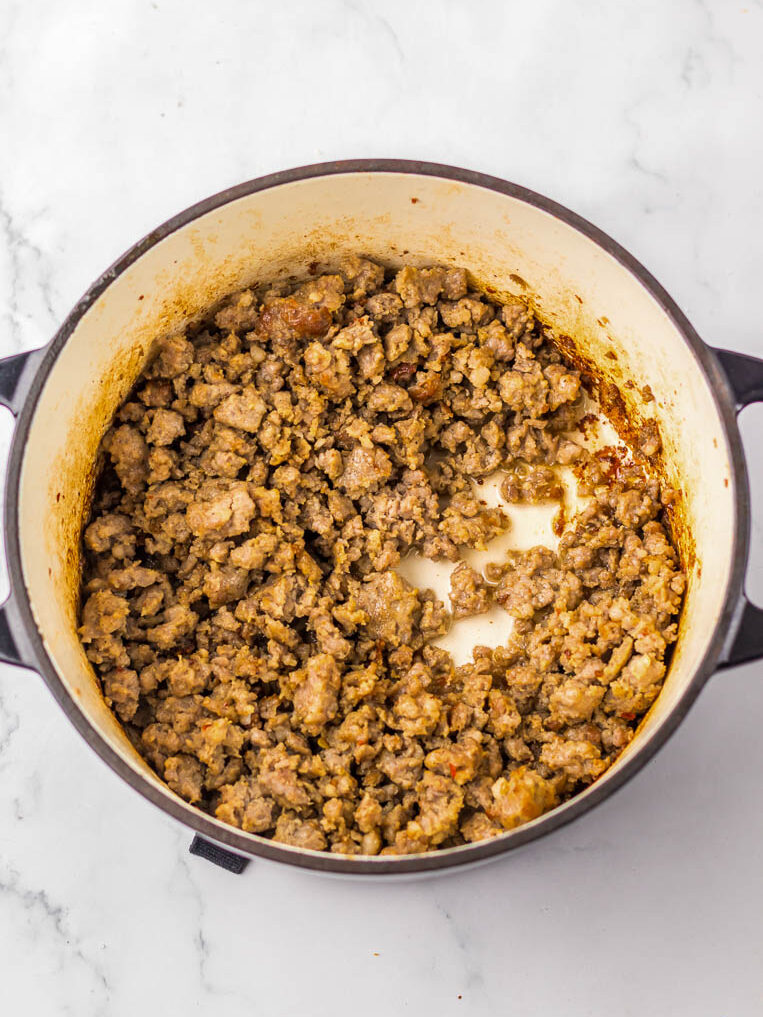 Cooked ground meat in a pot on a marble surface.
