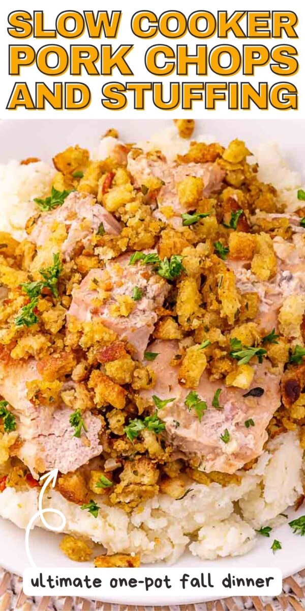 Close-up of slow cooker pork chops topped with stuffing and chopped parsley, served over mashed potatoes. Text overlay reads, "Slow Cooker Pork Chops and Stuffing" and "ultimate one-pot fall dinner.