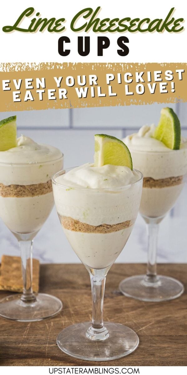 Three glasses filled with layered lime cheesecake dessert, topped with whipped cream and a lime wedge, displayed on a wooden surface.