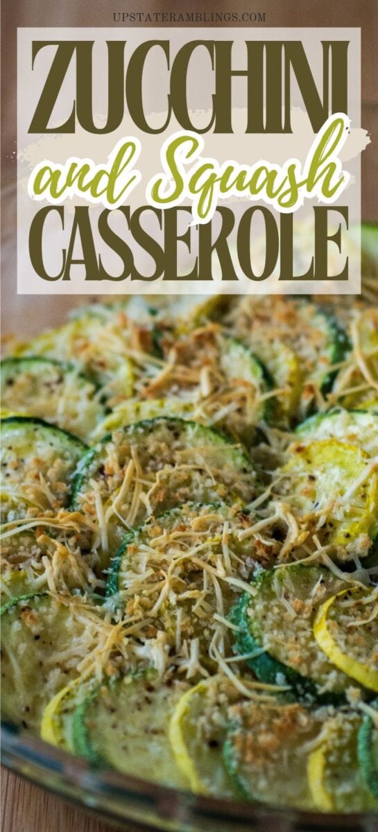 A baked zucchini and squash casserole topped with grated cheese and herbs, shown in a glass dish.