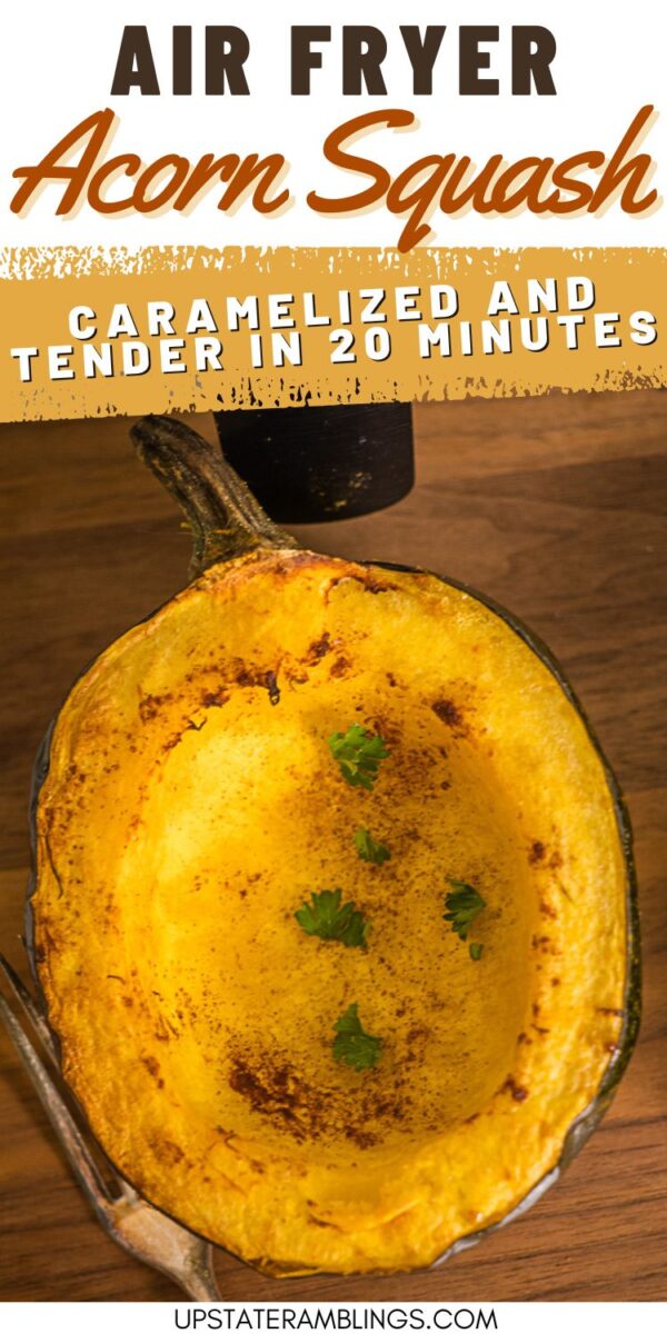 A cooked acorn squash half with browned edges and herbs, shown on a wooden surface, highlighting air fryer preparation.